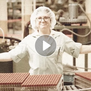 Smiling lab technician in production facility