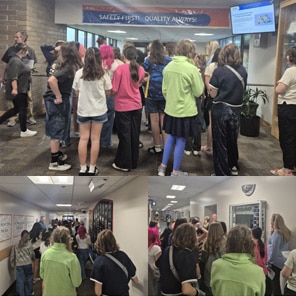 Students tour facility hallway safety display