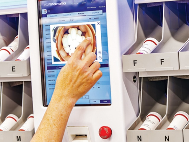 Finger pointing at image on monitor