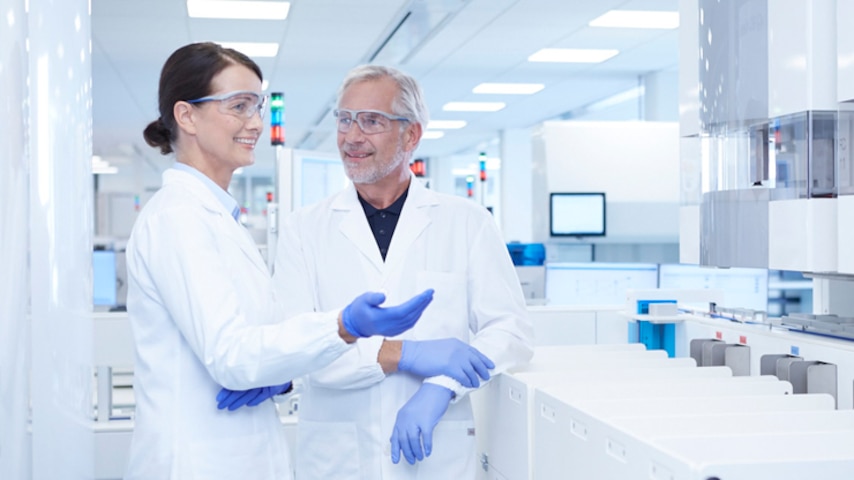 Lab technicians in white coats in their BD Kiestra automated lab 