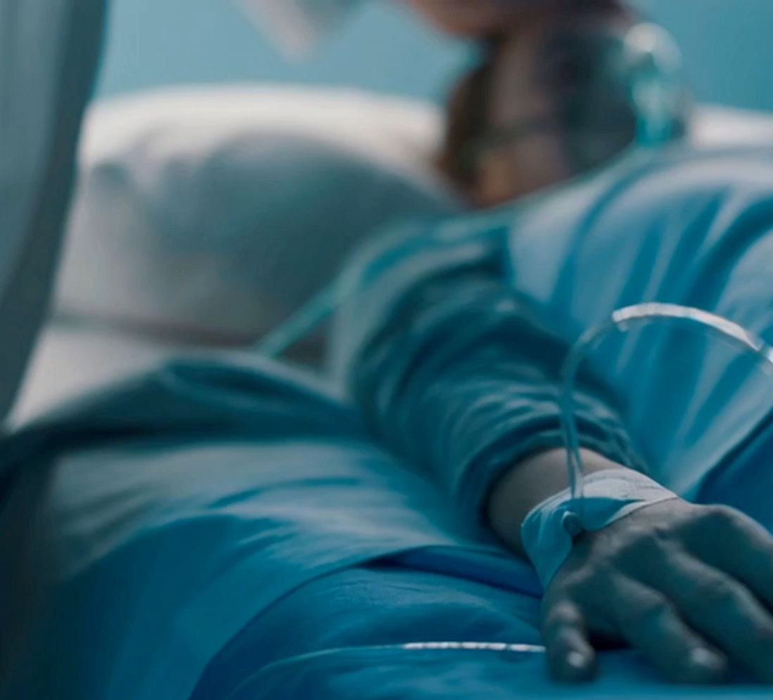 Doctor attends to a patient with an IV getting oxygen