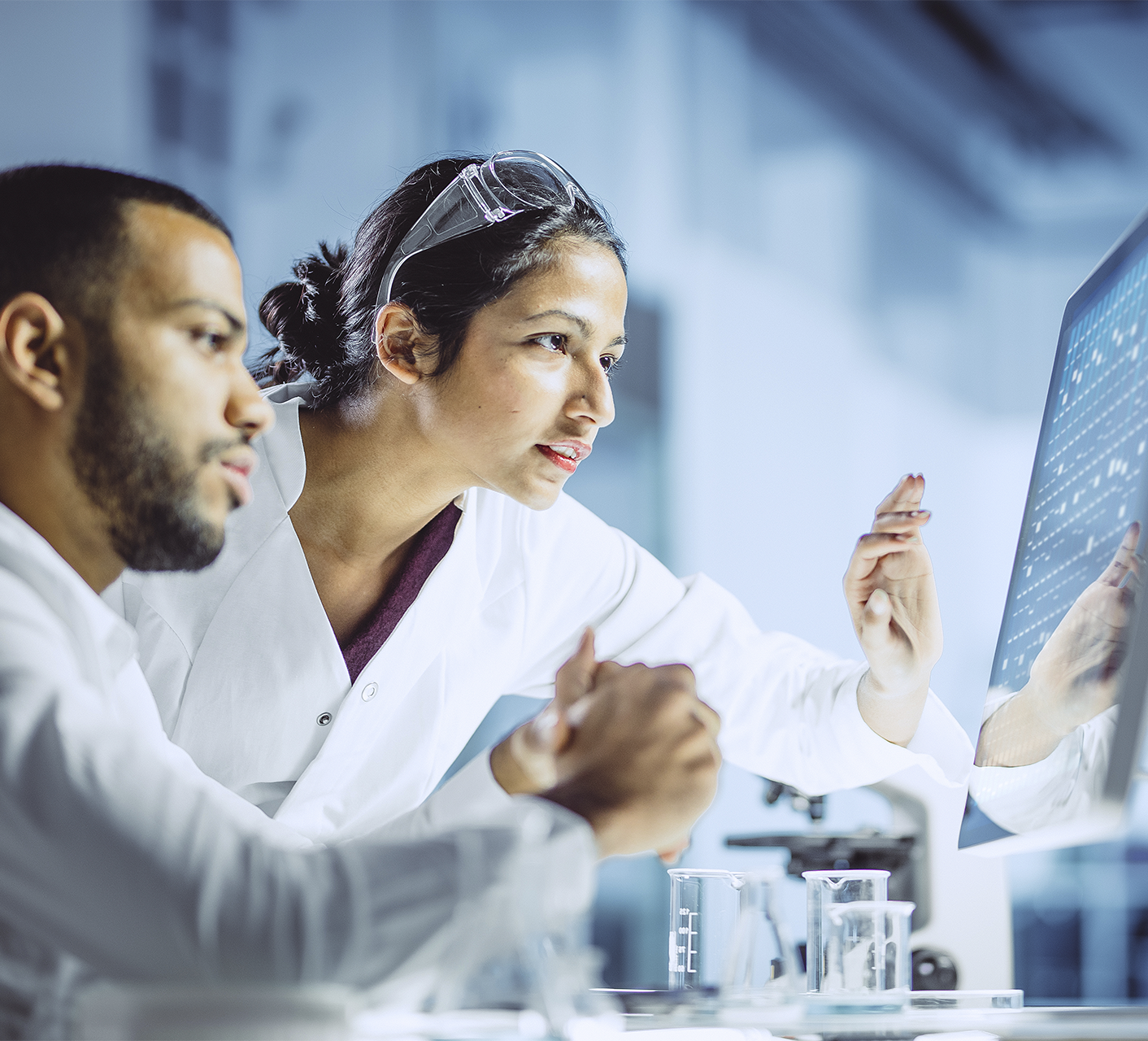 Scientists reviewing data on a monitor