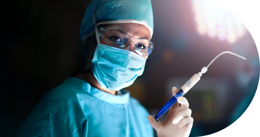 Surgeon holding avitene syringe in operating room