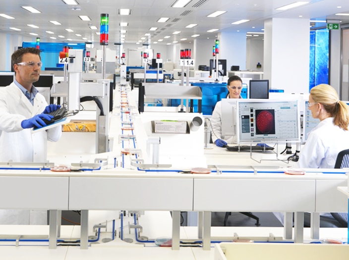 Lab techs working with integrated modern lab that uses BD Synapsys