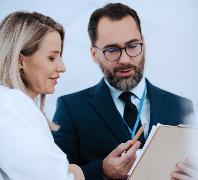 Professionals discussing document in office