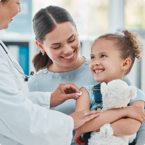 Doctor administering vaccine to young child