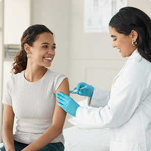 Smiling patient receiving vaccination from doctor