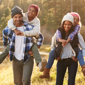 Family enjoying outdoor piggyback ride