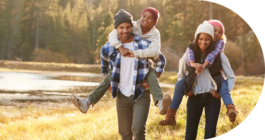 Family enjoying outdoor piggyback ride