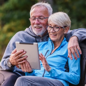 Couple using tablet outdoors in nature
