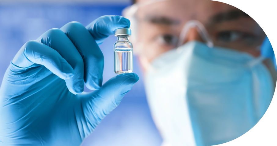 Gloved hand holding medical vial