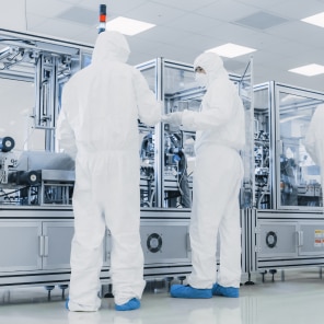 Technicians in Cleanroom Operating Advanced Machinery