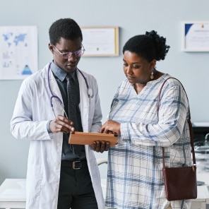 Doctor consulting patient in medical office setting