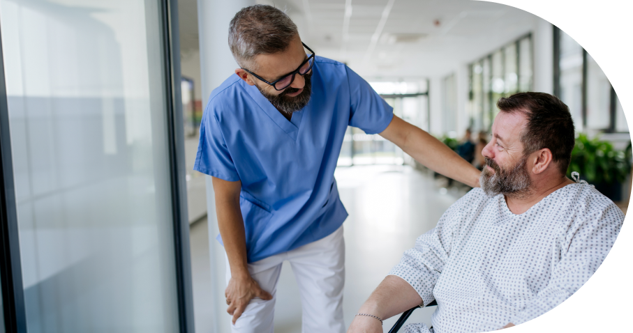 Healthcare worker comforting patient in hospital hallway