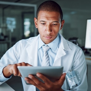 Doctor using digital tablet in modern office
