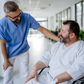 Healthcare professional comforting patient in hospital hallway