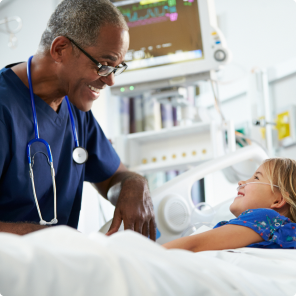 Nurse caring for child patient in hospital room