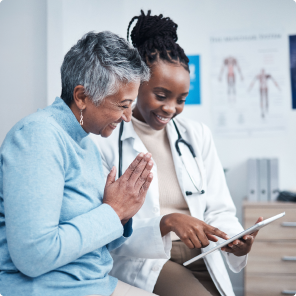 Doctor consulting patient using digital tablet in clinic