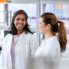 Two scientists in discussion inside laboratory setting