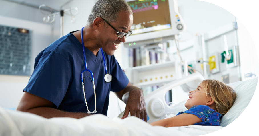 Doctor comforting young patient in hospital room