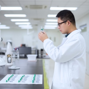 Scientist examining syringe in modern laboratory setting