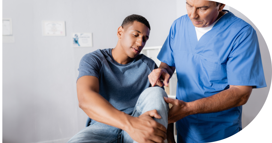 Physical therapist examining patient's injured knee