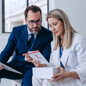 Doctor and businessman reviewing medical brochure