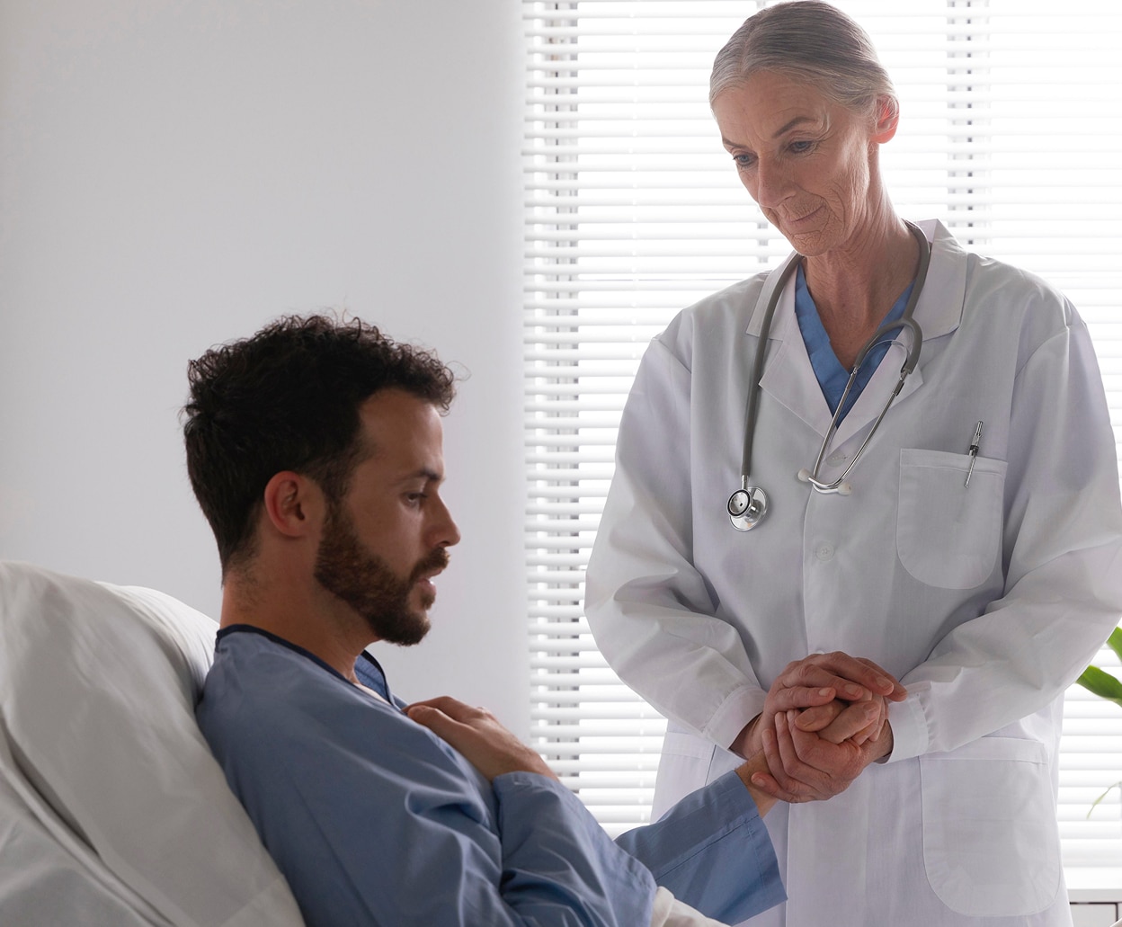 ill-male-patient-bed-talking-nurse-1-2